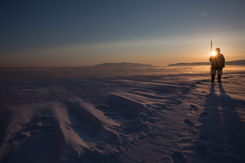 An Inuit hunter stands on the edge of the sea ice. Greenland.